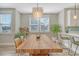 Bright dining area with modern light fixture, white walls, and a view into the stylish kitchen at 3941 Four Poles Park Dr, North Charleston, SC 29405