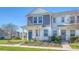 Charming two-story townhome with a well-kept lawn, inviting porch, and a vibrant blue door at 3941 Four Poles Park Dr, North Charleston, SC 29405