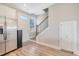 Foyer with a staircase, entry door, coat closet and stainless steel refrigerator on wood-look floors at 3941 Four Poles Park Dr, North Charleston, SC 29405