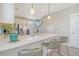 Open kitchen with a quartz countertop island, stainless steel appliances, pendant lighting and three bar stools at 3941 Four Poles Park Dr, North Charleston, SC 29405