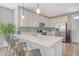 Bright kitchen featuring white cabinets, stainless steel appliances, breakfast bar, and stylish backsplash at 3941 Four Poles Park Dr, North Charleston, SC 29405