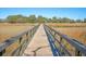 Long wooden boardwalk stretches through a golden marsh landscape, offering a peaceful nature experience at 3941 Four Poles Park Dr, North Charleston, SC 29405