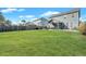 Expansive backyard featuring a well-manicured lawn, fenced perimeter, and a charming screened porch at 429 Cherrybark Oak St, Summerville, SC 29486