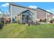 The large backyard features a lawn, landscaping and a screened in porch at 429 Cherrybark Oak St, Summerville, SC 29486