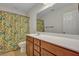 Bright bathroom featuring a floral shower curtain and a large mirror over the vanity at 429 Cherrybark Oak St, Summerville, SC 29486