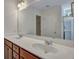 Bathroom with a double sink vanity, large mirror, and glass door shower at 429 Cherrybark Oak St, Summerville, SC 29486