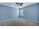 Bedroom features blue walls, neutral carpet, and a ceiling fan at 429 Cherrybark Oak St, Summerville, SC 29486