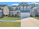 Charming two-story home featuring blue siding, white trim, a two-car garage, and a well-maintained front lawn at 429 Cherrybark Oak St, Summerville, SC 29486