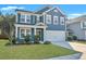 Beautiful two-story home featuring a two-car garage, a well-manicured lawn, and tasteful landscaping at 429 Cherrybark Oak St, Summerville, SC 29486
