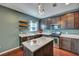 Well-lit kitchen features wooden cabinets, an island, stainless steel appliances and hardwood floors at 429 Cherrybark Oak St, Summerville, SC 29486