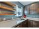 Modern kitchen features floating shelves, granite countertops, and stainless steel dishwasher at 429 Cherrybark Oak St, Summerville, SC 29486