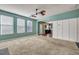 Spacious living room with a ceiling fan, kitchen view, carpet, and natural light at 429 Cherrybark Oak St, Summerville, SC 29486