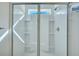 White tiled shower with a window, showerhead, and built-in shelves at 429 Cherrybark Oak St, Summerville, SC 29486