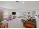 Spacious bonus room with carpet, couch, TV, ceiling fan, and playroom area at 433 Cedarview Rd, Summerville, SC 29486