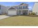 Inviting two-story home with a well-manicured lawn and attached garage at 433 Cedarview Rd, Summerville, SC 29486