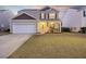 Charming two-story home with manicured lawn, inviting front porch, and attached two-car garage in a Gathering-friendly neighborhood at 433 Cedarview Rd, Summerville, SC 29486