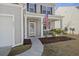 Charming front porch with tasteful decor, American flag, and cozy seating area at 433 Cedarview Rd, Summerville, SC 29486