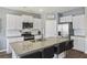 Modern kitchen with granite countertops, stainless steel appliances, and a spacious island with seating for casual dining at 433 Cedarview Rd, Summerville, SC 29486