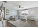 Comfortable living room with a large sectional sofa, a ceiling fan, decorative shelving, and soft natural light at 433 Cedarview Rd, Summerville, SC 29486