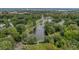 Aerial view of a lake surrounded by trees with neighborhood, featuring fountains and a walking path along its banks at 4816 Chesterfield Rd, North Charleston, SC 29405