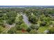 Aerial view of a serene lake surrounded by lush greenery and residential areas, offering a tranquil neighborhood setting at 4816 Chesterfield Rd, North Charleston, SC 29405