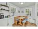 Bright dining area features wood table, cushioned benches, and natural light at 4816 Chesterfield Rd, North Charleston, SC 29405