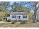 Charming single-story home with white siding, blue shutters and a detached garage at 4816 Chesterfield Rd, North Charleston, SC 29405