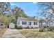 Charming single-story home with white siding, blue shutters and a detached garage at 4816 Chesterfield Rd, North Charleston, SC 29405