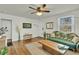 Bright living room with wood floors, a large area rug, and natural lighting at 4816 Chesterfield Rd, North Charleston, SC 29405