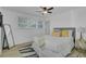 Well-lit bedroom with ceiling fan, neutral decor, and ample natural light, offering a comfortable and inviting space at 5332 Parkside Dr, North Charleston, SC 29405