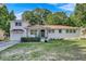 Charming brick home with a well-manicured lawn and inviting front porch and attached garage at 5332 Parkside Dr, North Charleston, SC 29405