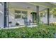 Inviting front porch with rocking chair and potted plants on a quaint brick home at 5332 Parkside Dr, North Charleston, SC 29405