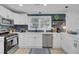 Bright kitchen featuring white cabinets, subway tile backsplash, and stainless steel appliances at 5332 Parkside Dr, North Charleston, SC 29405