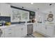 Bright kitchen featuring white cabinets, subway tile backsplash, and stainless steel appliances at 5332 Parkside Dr, North Charleston, SC 29405