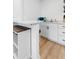 Well-lit kitchenette featuring white cabinets, a marble countertop, and stainless steel sink at 5332 Parkside Dr, North Charleston, SC 29405