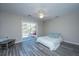 Open bedroom with sliding glass doors to the backyard, highlighting the wood-look flooring and a ceiling fan at 613 Salterton St, Summerville, SC 29485