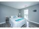 Comfortable bedroom showcasing soft gray walls, wood floor, and a queen-size bed with beach-themed accents at 613 Salterton St, Summerville, SC 29485