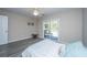 Bright bedroom with a sliding glass door leading to the patio, featuring a ceiling fan and modern flooring at 613 Salterton St, Summerville, SC 29485
