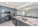 Kitchen featuring modern appliances, gray cabinets, and granite countertops at 613 Salterton St, Summerville, SC 29485