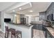 Updated kitchen with black cabinets, granite countertops, and a breakfast bar with seating at 613 Salterton St, Summerville, SC 29485