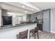 Renovated kitchen featuring gray cabinets, stainless appliances, and a breakfast bar area at 613 Salterton St, Summerville, SC 29485