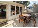 Relaxing back deck with a round wooden table and chairs, perfect for enjoying outdoor meals at 707 Palmetto Blvd, Edisto Island, SC 29438
