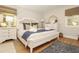 Cozy bedroom with a comfortable bed, soft pillows, and natural light from the windows, creating a peaceful retreat at 707 Palmetto Blvd, Edisto Island, SC 29438
