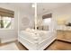 Bright bedroom featuring a four-poster bed, neutral decor, wood floors, and plenty of natural light at 707 Palmetto Blvd, Edisto Island, SC 29438
