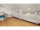 Bright attic bedroom with wood floors featuring three twin beds and a tv at 707 Palmetto Blvd, Edisto Island, SC 29438