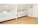Bright attic bedroom with wood floors featuring two twin beds and bright overhead lighting at 707 Palmetto Blvd, Edisto Island, SC 29438