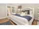Bedroom features a comfortable bed, soft pillows, ensuite access to a porch through glass french doors at 707 Palmetto Blvd, Edisto Island, SC 29438