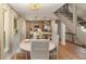 Cozy dining area showcases windows, staircase, adjacent kitchen, and stylish lighting at 707 Palmetto Blvd, Edisto Island, SC 29438