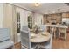 Bright dining area with a round table, seating for six, and an open kitchen layout at 707 Palmetto Blvd, Edisto Island, SC 29438