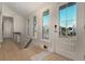 Bright and inviting entryway with natural light, hardwood floors, and modern finishes at 707 Palmetto Blvd, Edisto Island, SC 29438